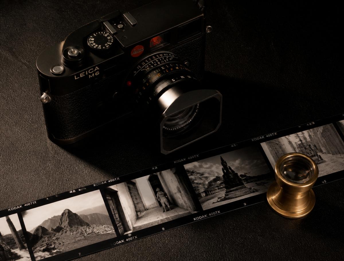 Leica film camera with black-and-white contact sheet and brass loupe